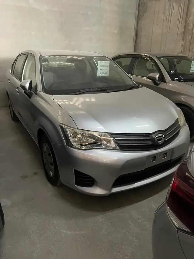 2012 Toyota Corolla Axio, silver sedan for sale at Rahaman & Sons, Success — in stock