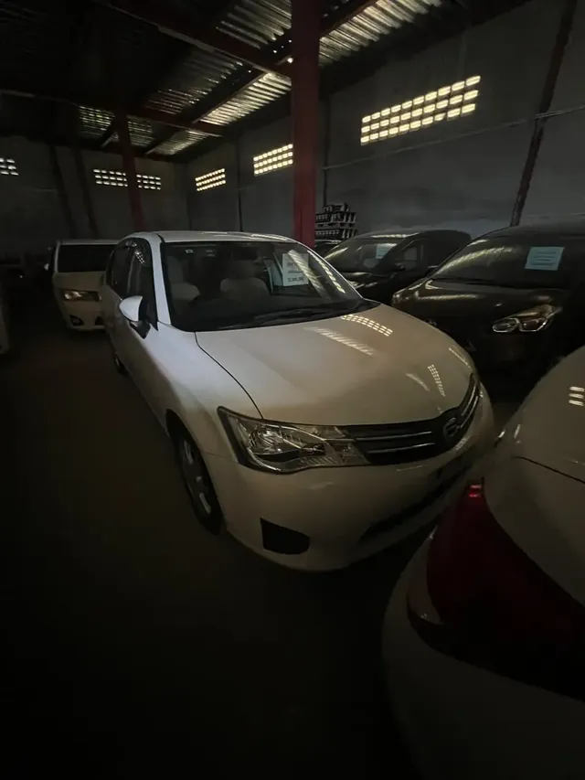 2014 Toyota Corolla Axio, white sedan for sale at Rahaman & Sons, Success — in stock